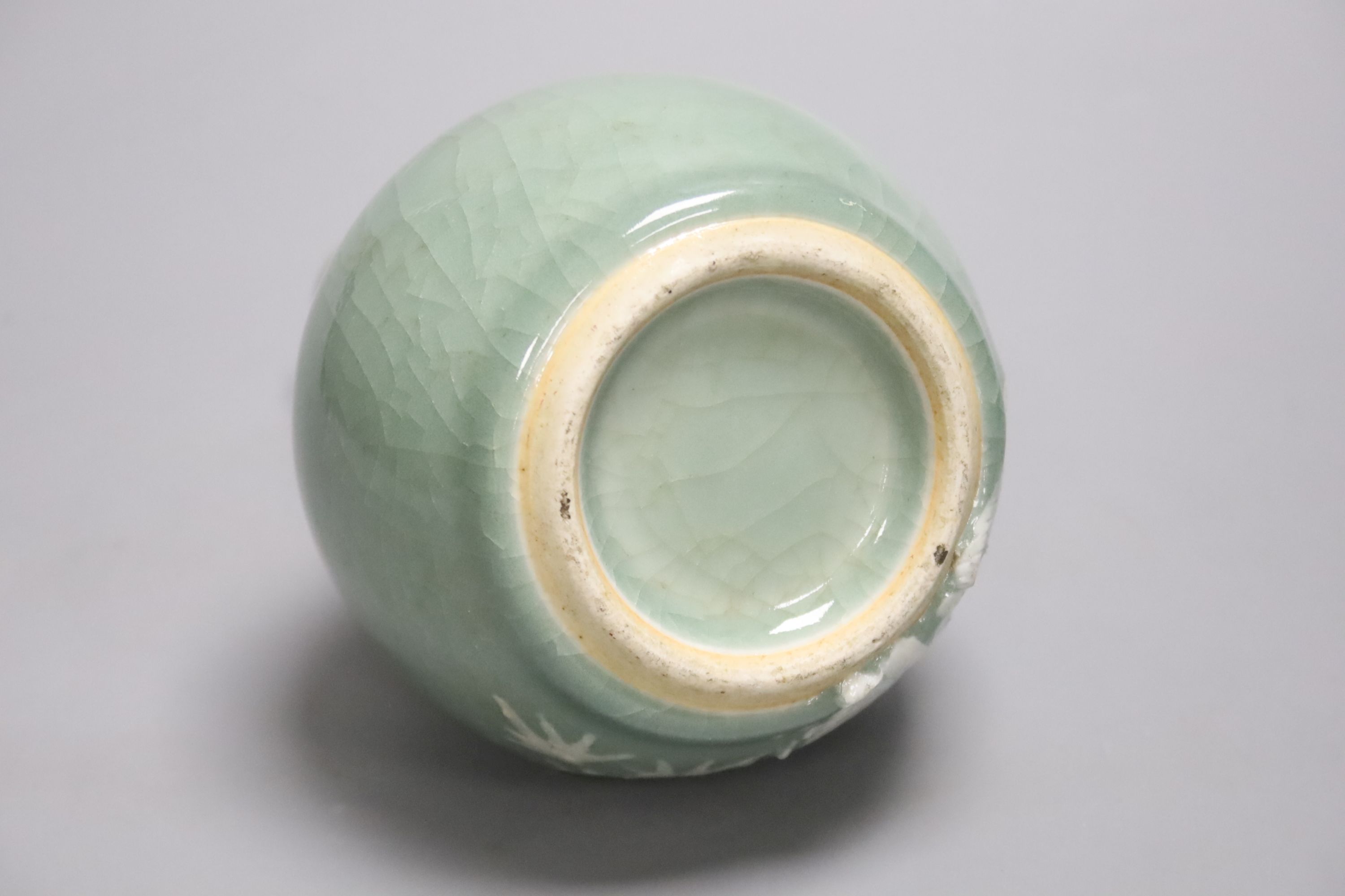 A Chinese celadon bottle vase with white slip decoration, 19th/20th century, height 20cm